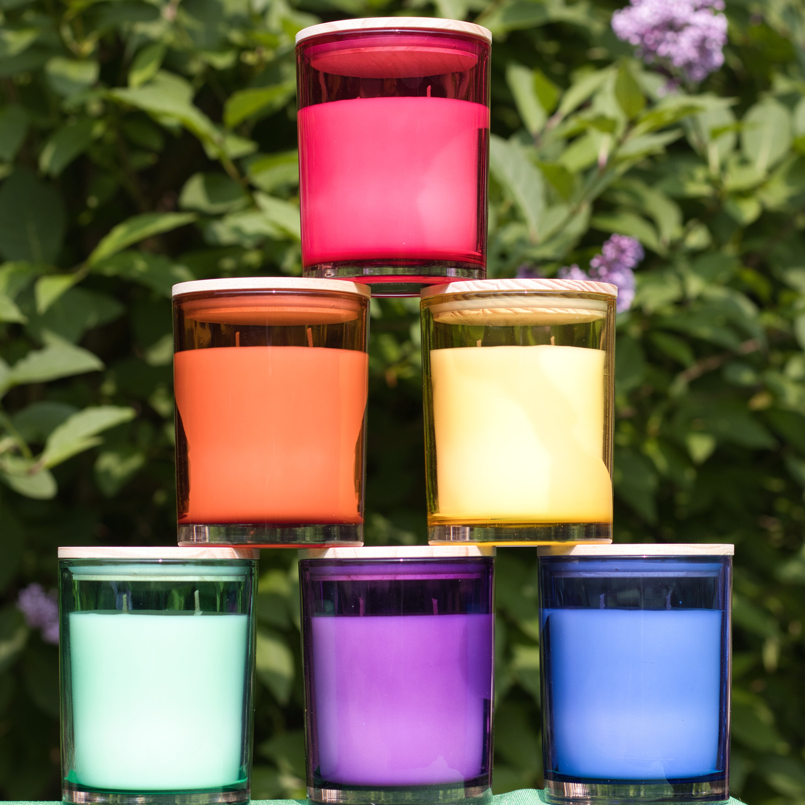 multicolored glass vessels in the shades of the rainbow stacked in a pyramid